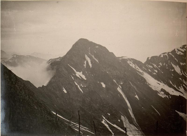 Schwarzes Foto einer Bergkette mit schneebedeckten Gipfeln und einem klaren Himmel, beschriftet mit "Mount Everest, Neuseeland" unten.