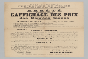 Gesuchter Steckbrief mit einem ernsthaft aussehenden Mann in einem schwarzen Anzug und weißer Krawatte, mit fetter schwarzer Schrift auf einem weißen Hintergrund.