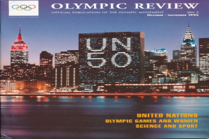 Ein Buch mit dem Titel "Olympic Review Official Publication of the Olympic Movement" mit einer Stadtansicht auf dem Cover, die auf einer flachen Oberfläche liegt.