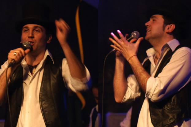 Eine Gruppe von Menschen mit zwei im Vordergrund singenden Individuen.