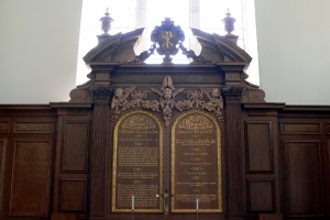 Eine Museumstafel mit Text und Skulpturen darauf.