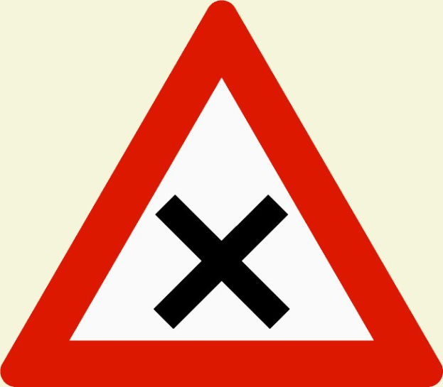 Rotes und weißes dreieckiges Warndreieck mit einem schwarzen Kreuz, das eine mögliche Überquerungsgefahr anzeigt.