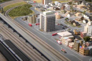 Ein Miniaturstadtmodell mit einer Bahn auf Schienen, umgeben von Gebäuden, Bäumen, Straßen, Fahrzeugen, Strommasten und Gras, mit einem Wolkenkratzer im Hintergrund.