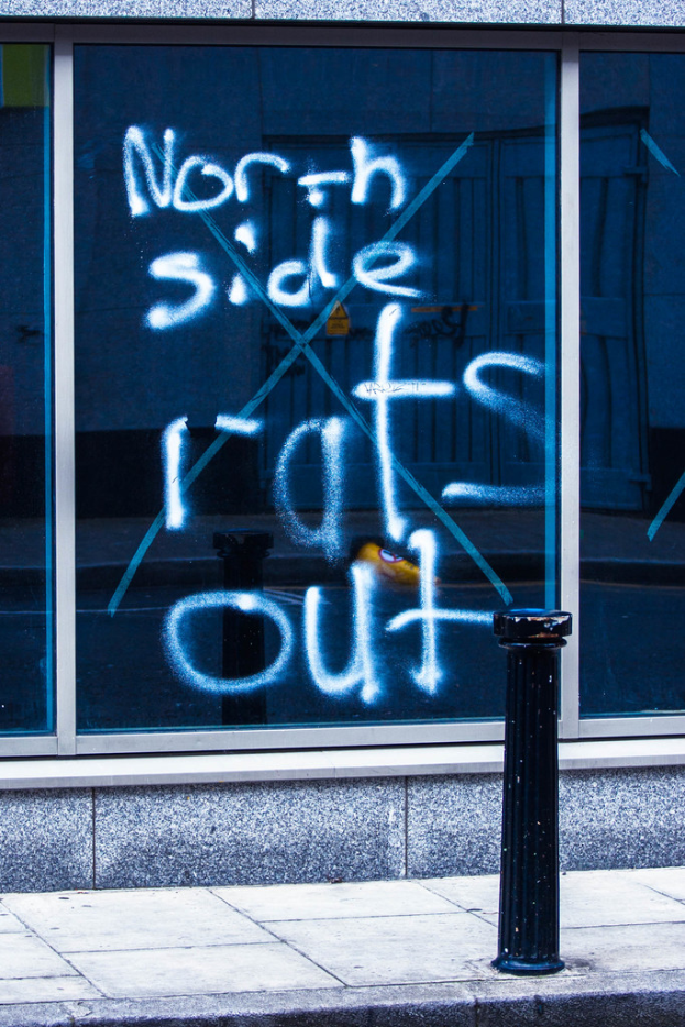 Text auf einem Fenster und einer Absperrstange auf der Straße.