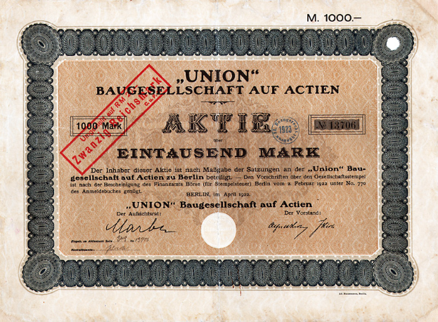 Ein alter deutscher Banknote mit einem roten Stempel und Text, der darauf hinweist, dass es ein Aktienzertifikat ist.